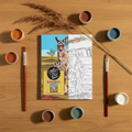 Kangaroos painting kit flat lay with brushes, paint pots and kangaroo grass on wooden tabletop